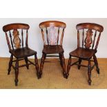 Three Victorian beech and ash country kitchen chairs with solid seats and upon turned legs,