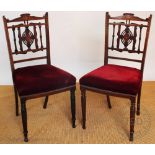 Two pairs of late Victorian inlaid rosewood chairs, with red upholstered seats, on turned legs,