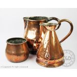 A 19th century large copper jug, 32cm, with a copper gallon measure dated 1954,