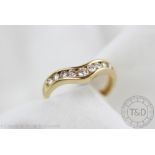 A diamond set ring, of shaped form and set with nine graduated brilliant cut diamonds,