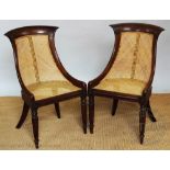 A pair of William IV mahogany sabre backed chairs, 19th century, with caned seat and back,