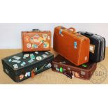 Five assorted suitcases to include a leather example,