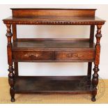 A Victorian carved oak three tier buffet, with two drawers (later handles), on turned legs,