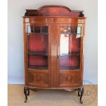 An Edwardian inlaid mahogany bow front display cabinet, with two glazed and panelled doors,