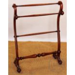 A Victorian mahogany towel rail of serpentine form,