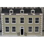 A modern dolls house modelled as a George III manor house, with six rooms,