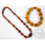 An amber coloured bead necklace and an amber coloured bead bracelet, gross weight 65.