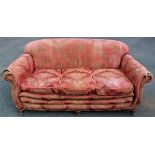 An early 20th century pink upholstered three seater sofa,