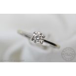 A diamond solitaire ring, the brilliant cut diamond, illusion set in 9ct white gold, stamped 'Dia .