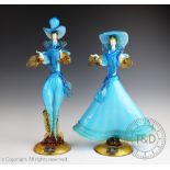 A pair of Murano glass figures, male and female companion in light blue and amber glass,