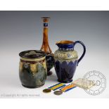 Three pieces of Royal Doulton Art Nouveau stoneware, to include; a pitcher 6824 20cm high,