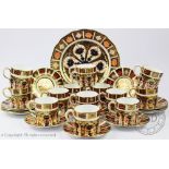 A set of thirteen Royal Crown Derby 1128 pattern coffee cans and saucers,