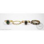 A selection of four rings, to include; an emerald and diamond cluster ring, all set in yellow gold,