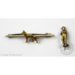 A gold dog brooch, the naturalistic Alsatian with textured finish set against a plain polished bar,