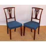 A set of four Edwardian inlaid mahogany dining chairs,