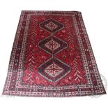 A bokhara type wool carpet, worked with three gulls against a red ground,