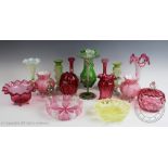 An assorted collection of coloured glass to include; enamelled trumpet vase,