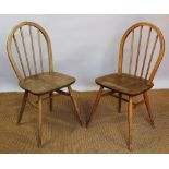 An Ercol elm dining table, on tapered legs, 71cm H x 148cm W x 75.