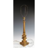 A 19th century gilt metal table lamp, modelled as an altar stick with floral and scroll detailing,