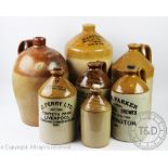 A collection of fourteen 19th century and later stoneware flasks with many named examples,