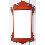 A George III mahogany fret cut wall mirror, with rectangular plate within a scroll frame,