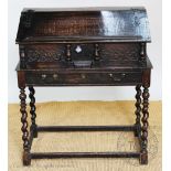 An 18th century and later oak bureau on stand, with fall enclosing seven drawers,