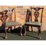 A pair of Chippendale style carved mahogany dining chairs,