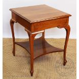 An Edwardian mahogany rectangular top occasional table, with shaped under tier, on cabriole legs,