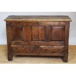An 18th century oak mule chest, with hinged top above a panelled top and sides, with two drawers,