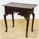 A George III and later oak low bow, with three drawers and serpentine apron, on cabriole legs,