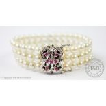 A cultured pearl bracelet with ruby set clasp,