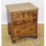 A George III style walnut bedside chest, with three long drawers, on bracket feet,