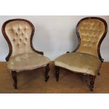 Two Victorian walnut button back nursing chairs,