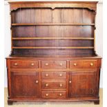 An early 19th century and later oak Shropshire type dresser and associated plate rack,