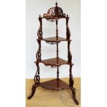 A Victorian carved walnut four tier corner what not, with fret cut detailing,