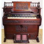 A late Victorian carved walnut piano organ by Bell,