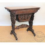 A late 19th century Burmese carved hard wood work table,