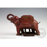 A cast iron novelty cigarette dispenser modelled as capronised elephant,