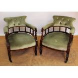 A pair of late Victorian walnut tub chairs, with pale green upholstery on ring turned legs,