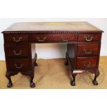 A 1920's mahogany pedestal desk, with leather inset top above seven drawers,