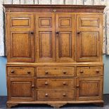 A late George III oak housekeepers cupboard,