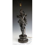 A late 19th century bronzed spelter figural lamp modelled as a cavalier, 75cm H (size excl.