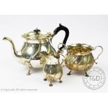 A late Victorian three piece silver tea service, Goldsmiths and Silversmiths Company Limited,