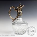 A Continental white metal mounted cut glass claret jug, possibly French,