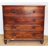 A Victorian mahogany chest of four long drawers, with turned bun handles and upon bun feet,