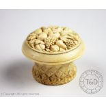 A late 19th century European carved ivory fruit basket box and cover, the cover carved with grapes,