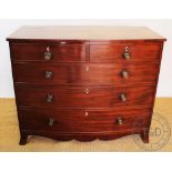 A Regency mahogany bow front chest, of two short and three long drawers, on splayed bracket feet,