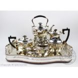 An early 20th century silver plated five piece tea service, including kettle on stand with burner,