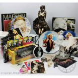 A collection of Marilyn Monroe memorabilia, including books, pictures,