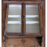 An early 20th Century pine display cabinet, glazed cupboard doors with brass mounted knobs,